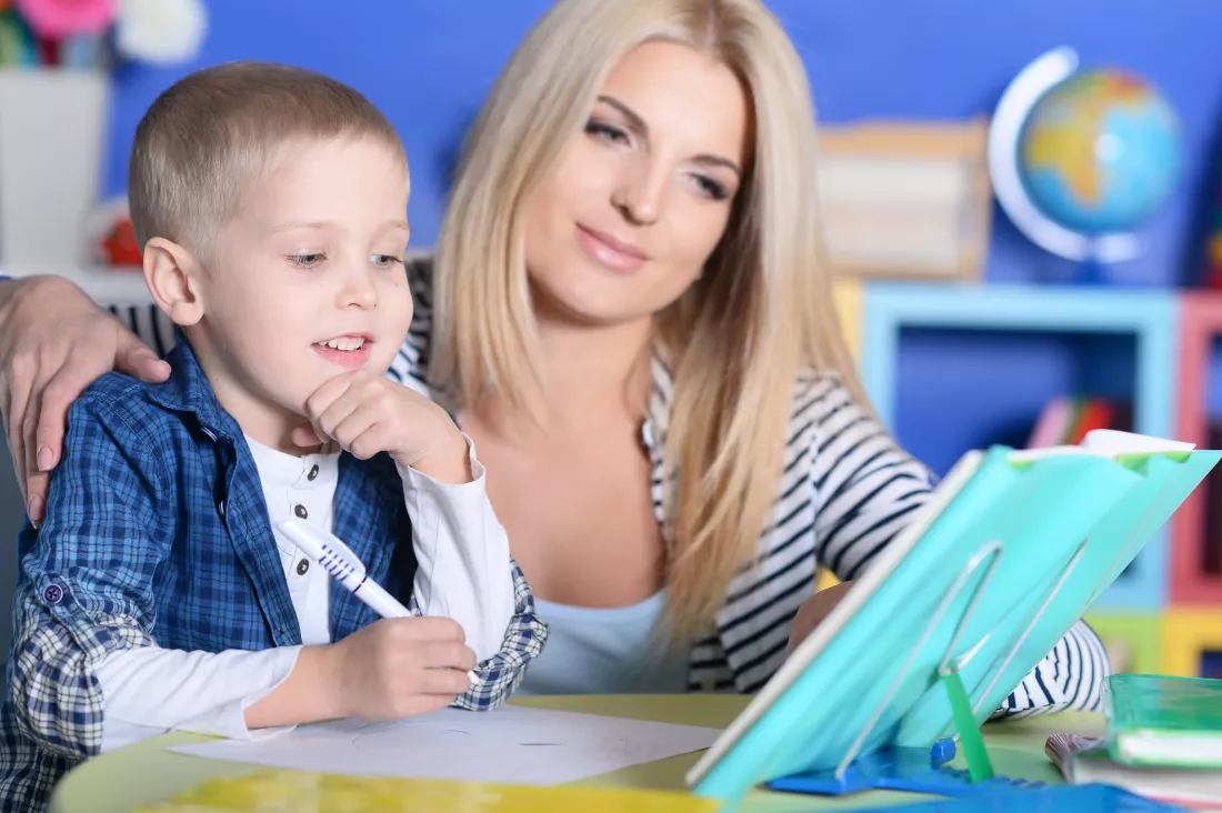 portrait-mother-helping-her-son-with-lessons
