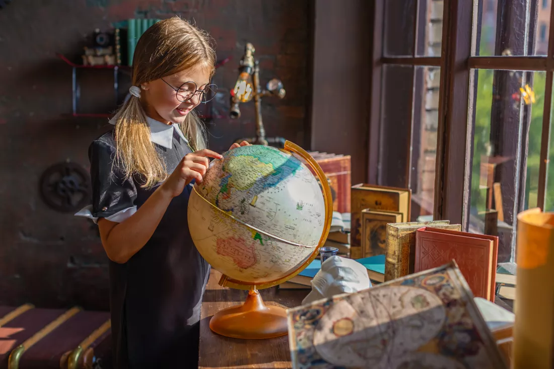 clever-schoolgirl-girl-with-glasses-looks-globe-surprise