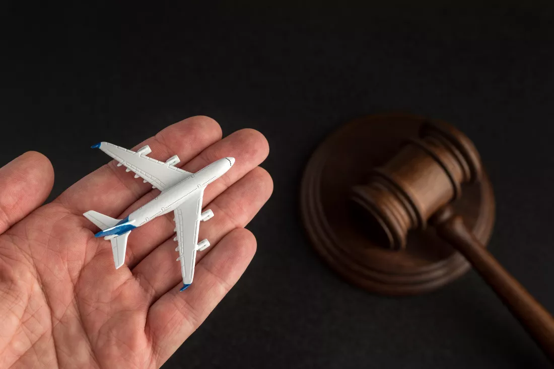 airplane-model-hand-background-wooden-judges-gavel-claim-airline